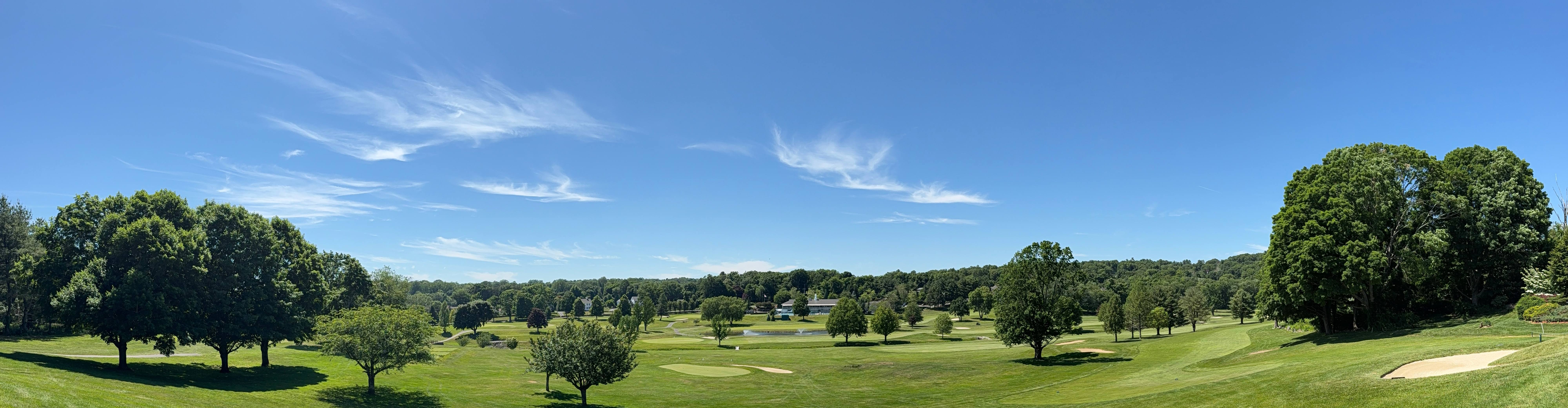 Panoramic view of Brownson Country Club's championship golf course with manicured fairways, bunkers, and rolling green hills in Huntington, Connecticut